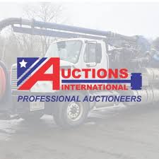 A large white truck with hoses is in the background. The foreground features the Auctions International logo with a stylized A, a star, and red, white, and blue text reading AUCTIONS INTERNATIONAL PROFESSIONAL AUCTIONEERS.
