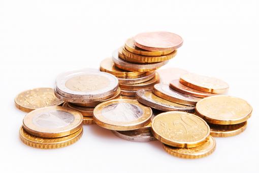 A pile of assorted euro coins, including gold, silver, and copper-colored coins, stacked and scattered on a white surface.
