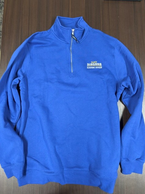 Blue quarter-zip pullover sweatshirt with SUNY Niagara Academic Advisor embroidered in white on the chest.